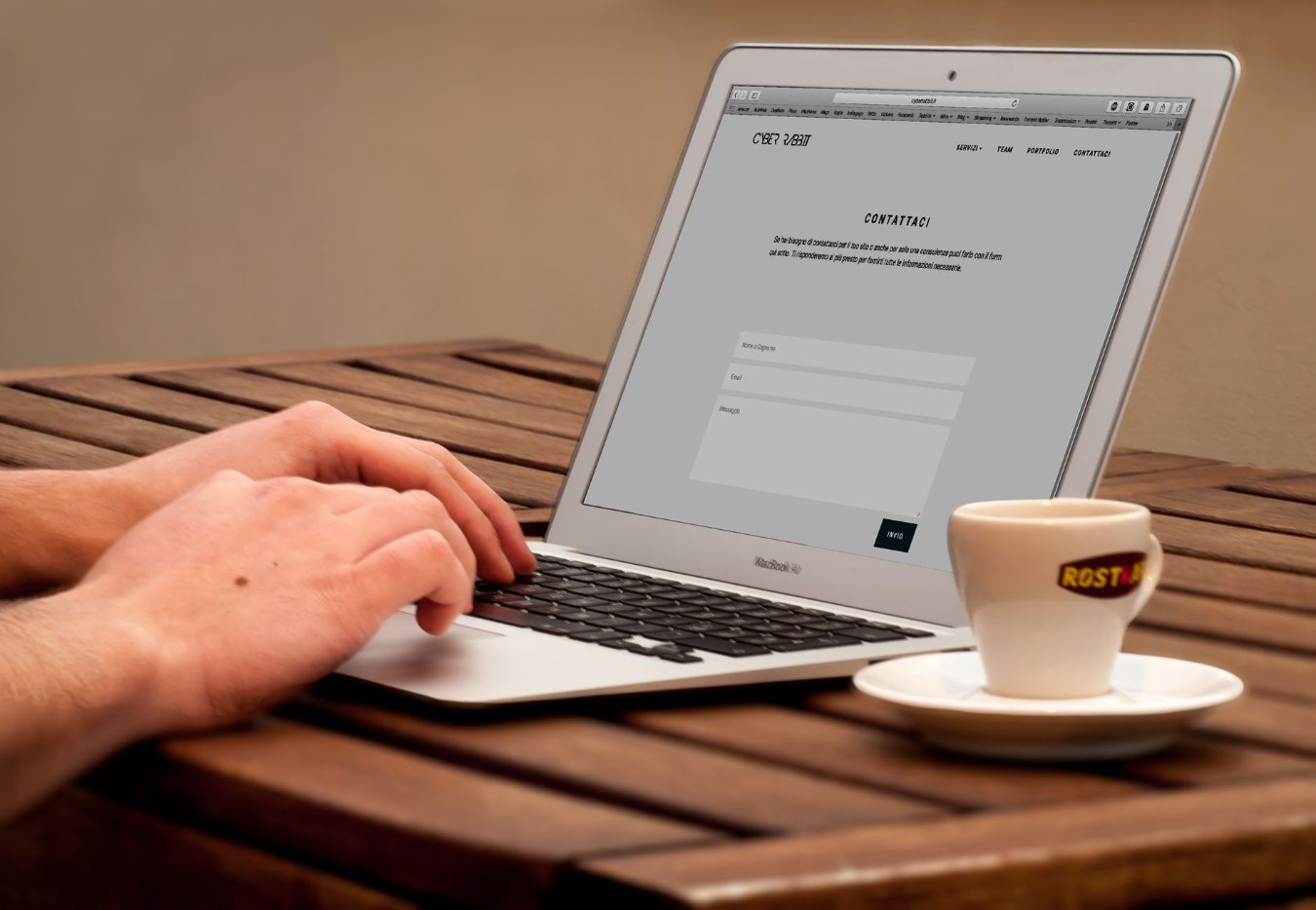 A web designer working on a website layout on a laptop